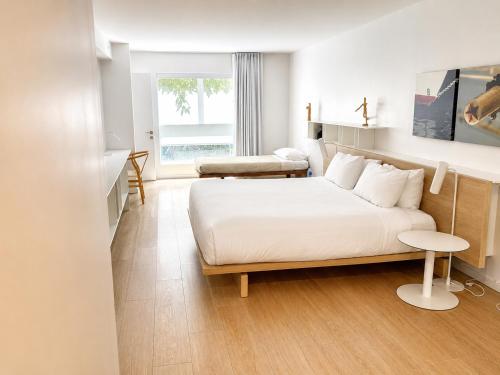 a hotel room with a bed and a window at Beach Haus Residences in Bal Harbour