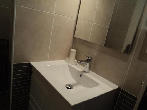 a bathroom with a white sink and a mirror at Vllla Reva in Argelès-sur-Mer
