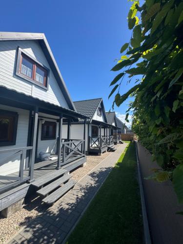 a row of houses are lined up in a row at Domki Prima Baltic in Sarbinowo