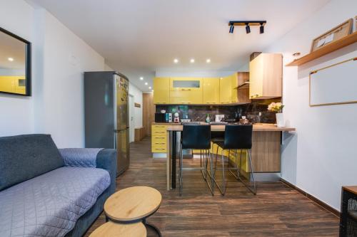 a living room with a couch and a kitchen at Apartment Niksa in Pula