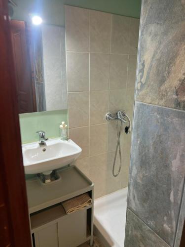 a bathroom with a sink and a shower at Amarynthos Tiny Retreat in Amarynthos