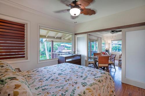 a bedroom with a bed and a table and chairs at Hanalei Colony Resort H4 in Hanalei