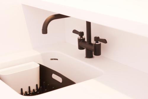a bathroom with a sink and a faucet at Quinta Do Miguel in Aldeia do Meco