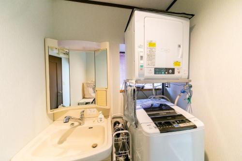 a hospital bathroom with a sink and a mirror at コテージひだまり in Izunokuni