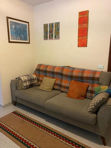 a living room with a couch with pillows on it at Casale Vista Mutria in Vinchiaturo