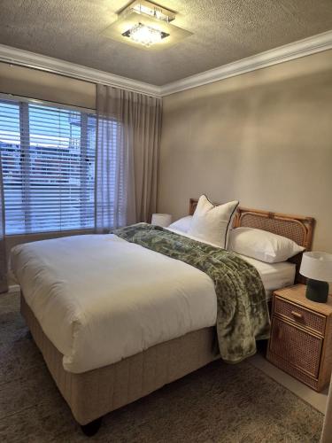 a bedroom with a large bed and a window at Fortune Lux - Tygerwaterfront in Tyger Valley