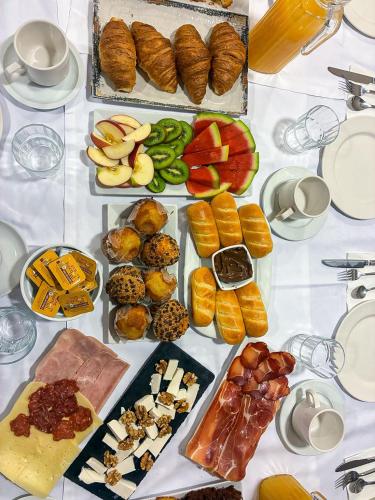 a table with many different types of food on it at Vestigia Nueva Castilla in Sigüenza