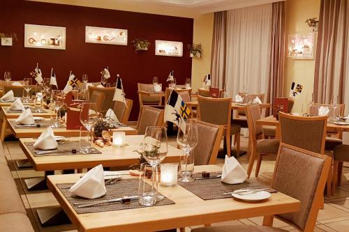 ein Esszimmer mit Holztischen und Stühlen in der Unterkunft Typically Swiss Hotel Altana in Scuol