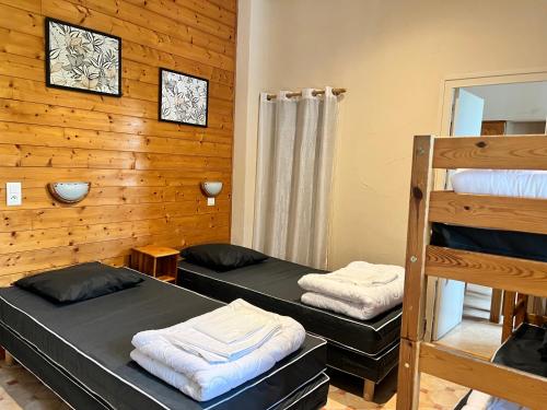 a room with two bunk beds and a ladder at Résidence Les Dômes in Murol