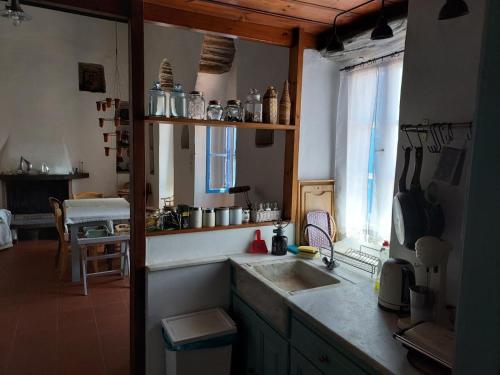 a kitchen with a sink and a counter top at Alba Andros Traditional Villa in Andros