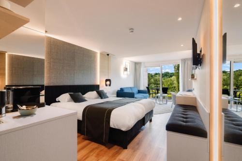 a hotel room with a bed and a couch at Hotel - Appartement de Zevende Heerlijkheid in Slenaken