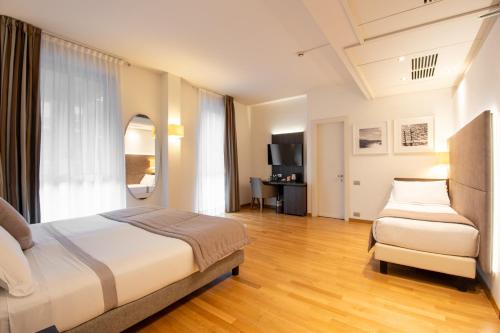 a hotel room with a bed and a chair at Hotel Como in Como
