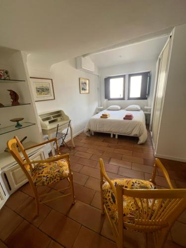 a bedroom with a bed and a table and chairs at Authentic village house in Goult