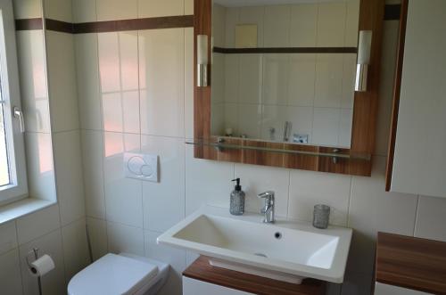 a bathroom with a sink and a toilet at Gästehaus Manuela in Lind