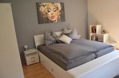 a bedroom with a bed with a painting on the wall at Gästehaus Manuela in Lind