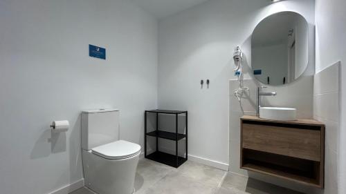 a bathroom with a toilet and a sink and a mirror at Hotelito Boutique Madrid Auditorio in Madrid