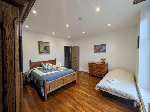 a bedroom with a bed and a dresser in it at maison des chanoines in Toul