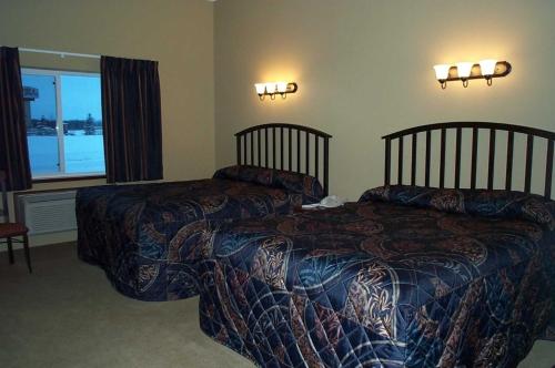 a bedroom with two beds and a window at Americas Best Value Inn Big Lake Becker in Big Lake