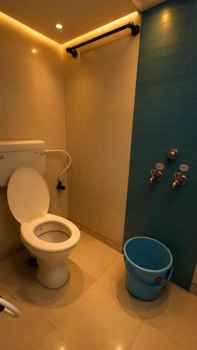 a bathroom with a toilet and a shower at M R Hotels in Visakhapatnam