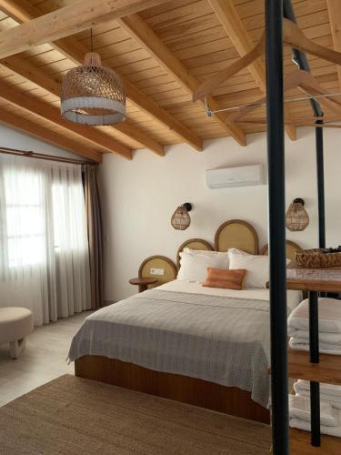 a bedroom with a bed and a wooden ceiling at Molo Urla in Urla