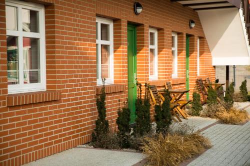 a brick building with benches on the side of it at Mistral Ustka in Ustka