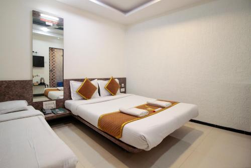 a bedroom with a large bed in a room at New Vyankatesh in Mahabaleshwar