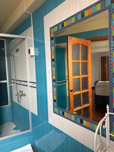 a bathroom with a mirror in a room at The House in Tacna