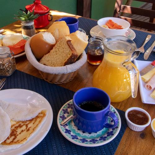 a table with a plate of bread and a cup of coffee at Pousada La Vie Jeri in Jericoacoara
