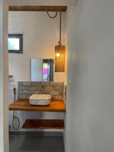 a bathroom with a sink with a stone counter at Sumar your beach house in Japaratinga in Japaratinga