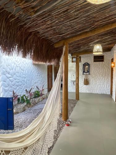 a hammock in a room in a house at Sumar your beach house in Japaratinga in Japaratinga
