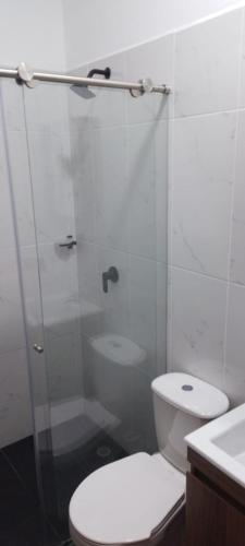 a bathroom with a shower and a toilet and a sink at Apartamento C&B in Bello
