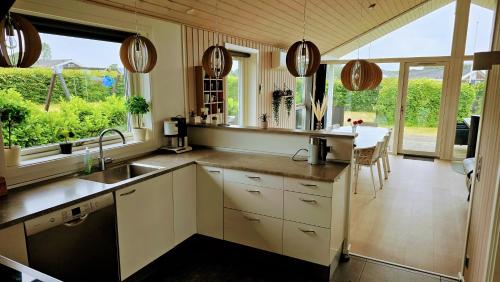 a kitchen with a sink and a table in it at Holiday Home Als - Starfish in Nordborg