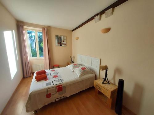 a bedroom with a large bed and a window at Le Liboureau in Saint-Jean-de-Vaux