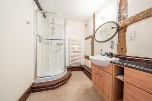 a bathroom with a shower and a sink and a mirror at Kings Arms Hotel in Cleobury Mortimer