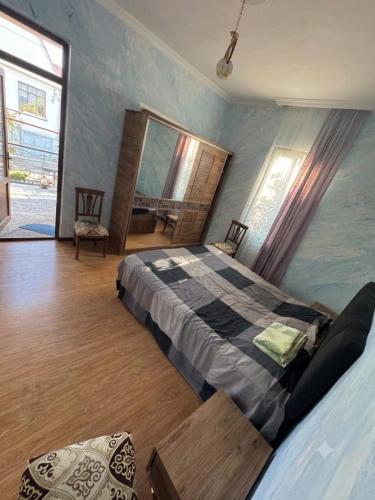 a bedroom with a large bed in a room at Cozy-home in Kobuleti