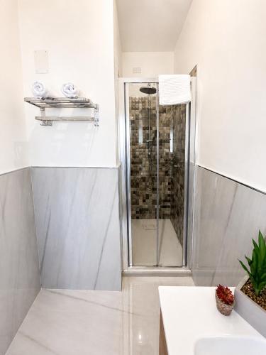 a bathroom with a shower and a sink at O'Chianu in Lascari