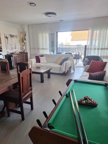 a living room with a pool table and a couch at Marina Seaside Escape in Malinska