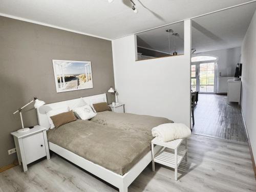 a bedroom with a bed and a chair in it at Ferienhof-Wohler-Wohnung-4 in Bojendorf