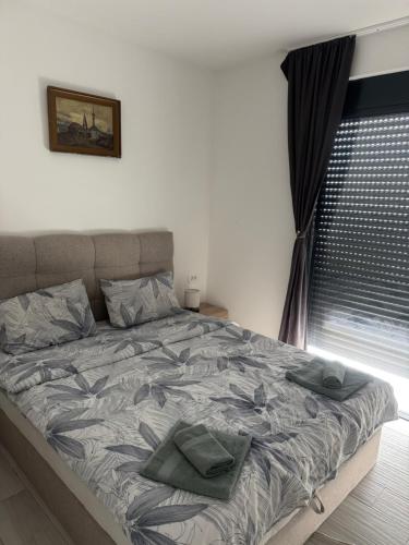 a bed with two pillows on it in a bedroom at Stanisicguesthouse in Stanišiči