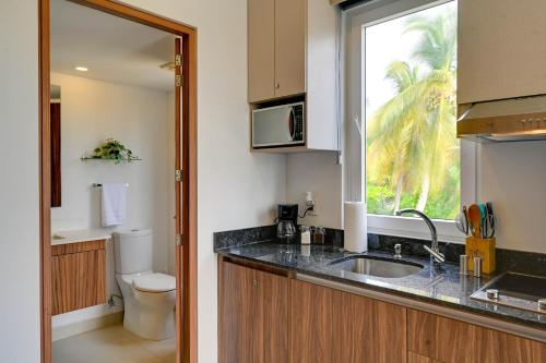 a kitchen with a sink and a toilet and a window at Explore Nature & Beaches! Nuevo Nayarit Condo in Nuevo Nayarit
