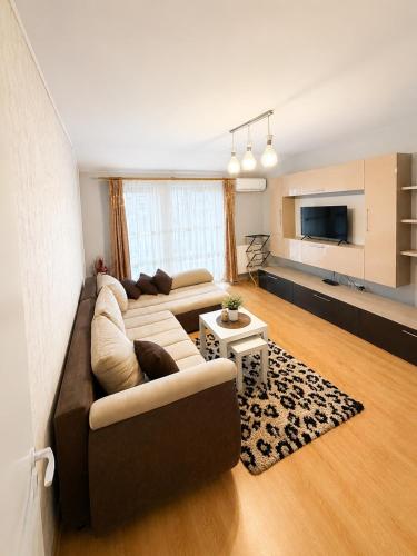 a living room with a couch and a table at Magda's Apartments in Braşov