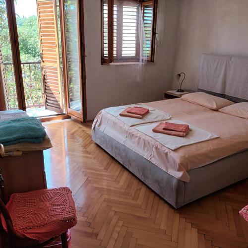 a bedroom with a bed with two towels on it at Apartment ANDRIUCI in Cavtat