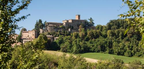 a castle on top of a hill with trees at Castello di Tabiano in Tabiano