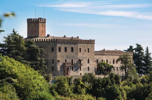 a castle on top of a hill with trees at Castello di Tabiano in Tabiano
