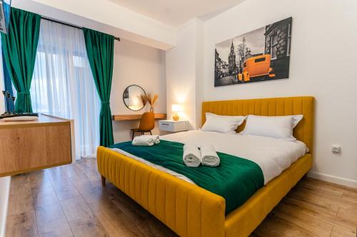 a bedroom with a large bed with shoes on it at Apartament23 Sibiu in Şelimbăr
