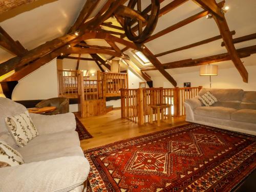 a living room with two couches and a rug at The Water Mill at Boyton Mill in Launceston