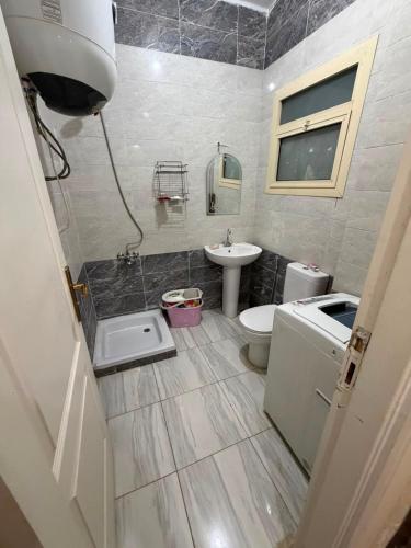 a bathroom with a toilet and a sink at Tahiti North coast in Al Ḩammām