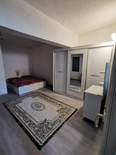 a small room with a bed and a rug at PRISHTINA Stay in Prishtinë