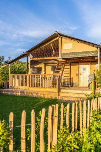 a house with a fence in front of it at Camp de Rêves Glampsite in St Peter