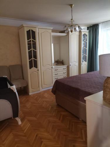 a bedroom with a bed and a dresser at Апартамент Граф Игнатиев in Varna City
